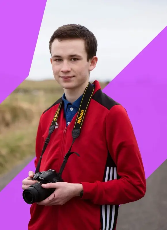 Young person on Uist holding a camera